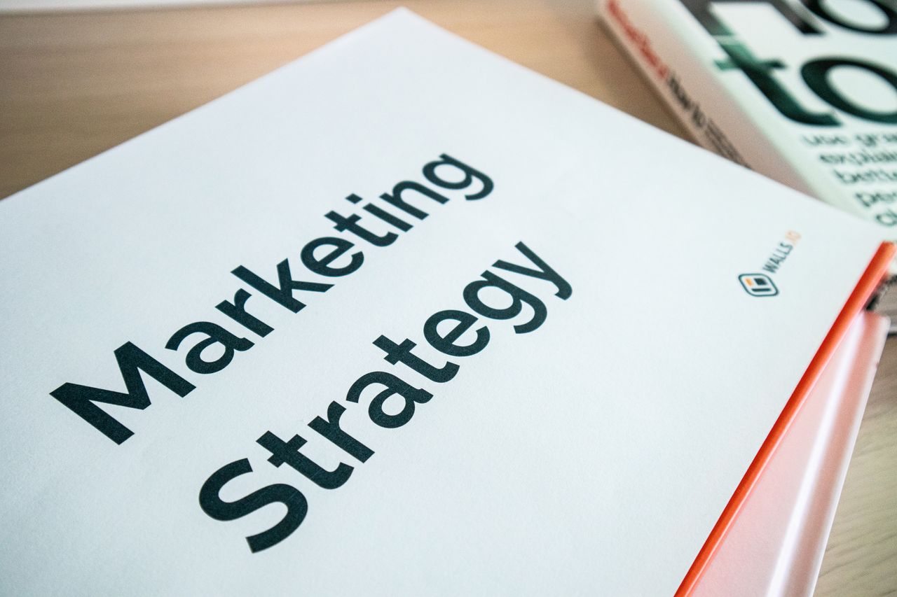experience-img Close-up of a marketing strategy document on a desk, ideal for business content.