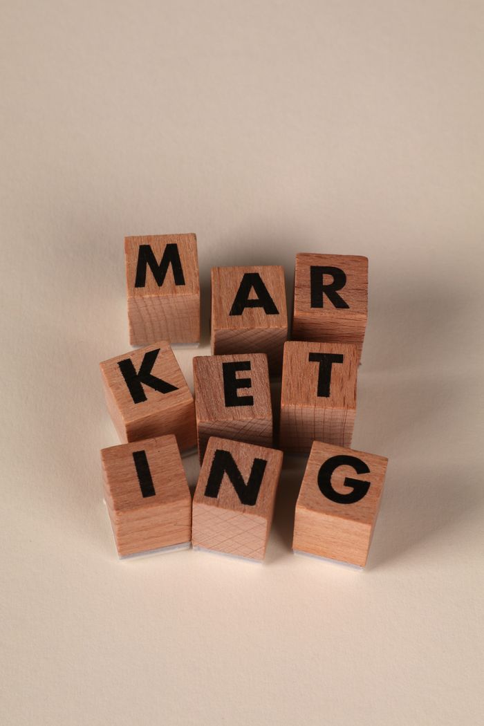 who-we-are-img Wooden blocks arranged to spell MARKETING on a neutral background.